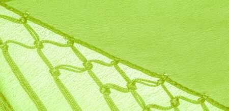 Background texture of silk fabric. This is a natural green salad scarf, this beautiful nylon satin...