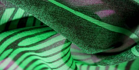 texture background pattern wallpaper. Green pink black silk fabric pattern. This medium-weight rayon fabric has a nice shine with slight color variations. Perfect for adding elegance to your designsの写真素材
