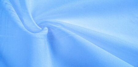 texture background, pattern.  silk blue fabric. From Telio, this organza has a thin, open weave that is thicker and sharper than silk gauze. Use this luxurious fabric for anything. The possibilities are really endless!の写真素材