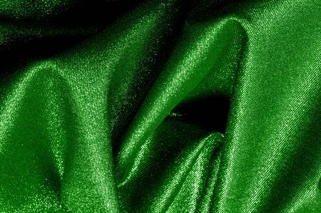 Texture, background, pattern. The fabric is Dark green coated with a metallic silver thread. These fabrics are ideal for any project, wallpaper, all design solutions. and many uses of shipsの写真素材