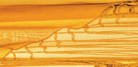 Background texture of silk fabric. This is a natural yellow scarf, this beautiful nylon satin made...