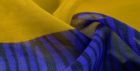 texture background pattern wallpaper. blue black yellow silk fabric pattern. This medium-weight rayon fabric has a nice shine with slight color variations. Perfect for adding elegance to your designsの写真素材