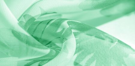 Texture background, pattern, wallpaper. white silk fabric, green print. This silk lightweight fabric...
