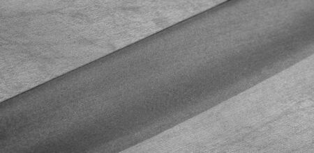 Background texture of silk fabric. This is a natural black scarf, this beautiful nylon satin made of...