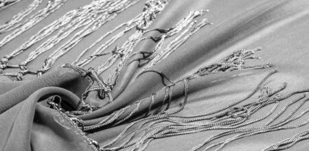 Background texture of silk fabric. This is a natural black scarf, this beautiful nylon satin made of rayon with a transparent hand and a wonderful sheen is perfect for your projects..の写真素材