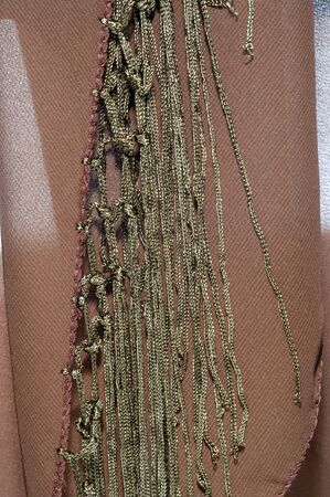 Background texture of silk fabric. This is a natural brown scarf, this beautiful nylon satin made of...