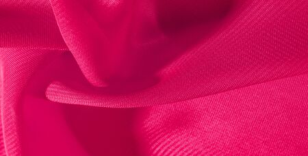 texture background pattern red silk fabric. This silk organza has a gentle open weave. Use this luxurious fabric for anything from your design for special occasions to creating your projects.の写真素材