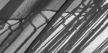 Background texture of silk fabric. This is a natural black scarf, this beautiful nylon satin made of...