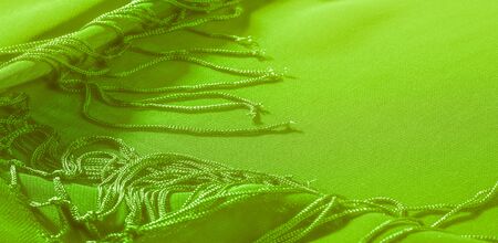 Background texture of silk fabric. This is a natural green salad scarf, this beautiful nylon satin made of artificial silk with a transparent hand and a wonderful sheen is perfect for your projects.の写真素材