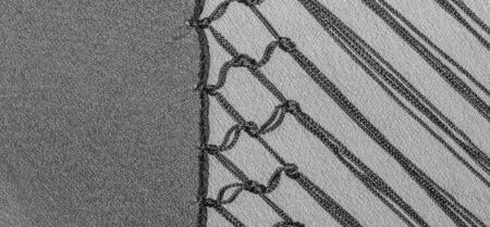 Background texture of silk fabric. This is a natural black scarf, this beautiful nylon satin made of...