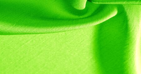 Background, pattern, texture, wallpaper, green silk fabric. It has a smooth matte finish. Use this luxurious fabric for anything - from design to your projects. The possibilities are truly endless!の写真素材
