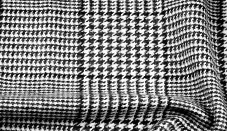 Background texture, pattern. The fabric is thick, warm with a checkered pattern, gray black. This is...