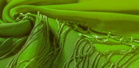 Background texture of silk fabric. This is a natural green salad scarf, this beautiful nylon satin...