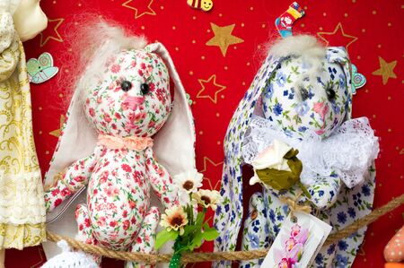 Flea market,  folk crafts. Handmade rag dolls. A rag doll is a children's toy. It is a cloth figure,...