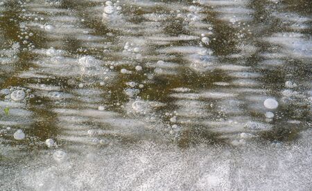 There is frost on the street, ice on the river, ice bubbles stuck in ice, unusually colorful ice...