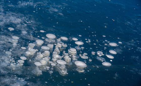 There is frost on the street, ice on the river, ice bubbles stuck in ice, unusually colorful ice...