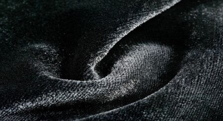 Texture background, pattern. Black Velveteen. This magnificent elastic velor fabric has a velvety nap. Pan pan adds shine and texture! It has a knitted back and is great for your design.の写真素材