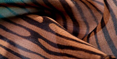 texture, background, pattern, wallpaper. brown silk fabric pattern. This medium-weight rayon fabric has a nice shine with slight color variations. Perfect for adding elegance to your designs.の写真素材