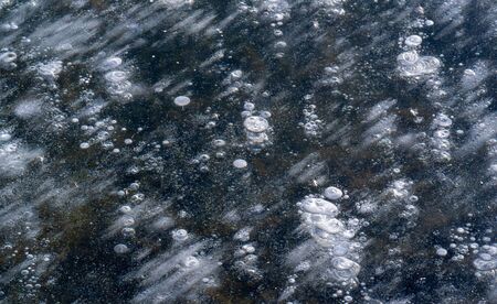 There is frost on the street, ice on the river, ice bubbles stuck in ice, unusually colorful ice...