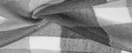 Texture, background, silk scarf feminine black and white with a metal stripe. The scarf is decorated...