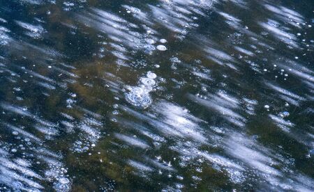 There is frost on the street, ice on the river, ice bubbles stuck in ice, unusually colorful ice...