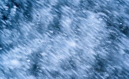 There is frost on the street, ice on the river, ice bubbles stuck in ice, unusually colorful ice architectureの写真素材