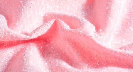 background, pattern, texture, ornament, vintage. pink fabric with artificial pellets. pellet, roll.  this high-quality lightweight stretch cotton jersey knit fabric features a smooth handの写真素材