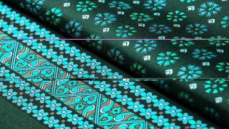 silk fabric of green color with blue and white flowers, dense fabric, bilateral on the basis of...