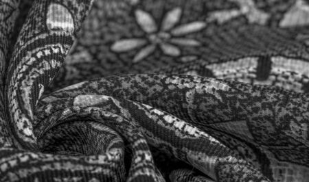 Background design texture, black and white, silk fabric with white drawings of flowers circles. Charmeus has a beautiful drapery. It can be assembled in soft fullness.の写真素材