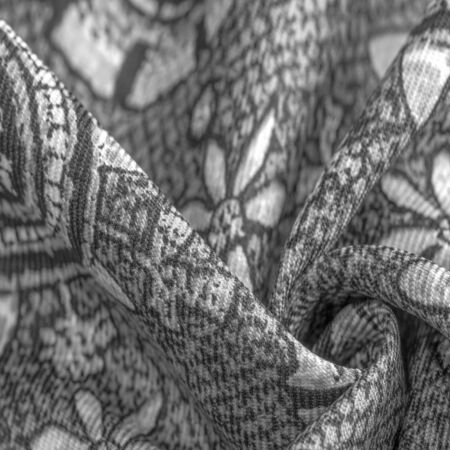 Background design texture, black and white, silk fabric with white drawings of flowers circles. Charmeus has a beautiful drapery. It can be assembled in soft fullness.の写真素材