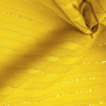 Design background texture, yellow amber fabric with lurex stripes, perfect for a fresh and comfortable style.の写真素材