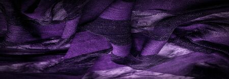 Texture, background, design, light transparent silk fabric of violet color, Soft-touch material is...