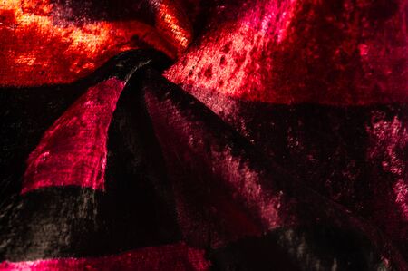Texture, background, pattern, design, red yellow brown velvet fabric, dense fabric of silk, cotton or nylon with a thick short pile on one side.の写真素材