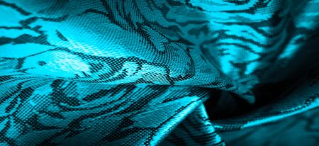 relief pattern, composite textiles, blue silk fabric with a floral pattern, unusually pleasant visual sensations: slippery, coolness, softness; beautiful appearance, unique shine;の写真素材