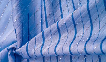 Texture background design, blue fabric with azure and white stripes of lurex, perfect for a fresh...