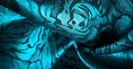 relief pattern, composite textiles, blue silk fabric with a floral pattern, unusually pleasant visual sensations: slippery, coolness, softness; beautiful appearance, unique shine;の写真素材