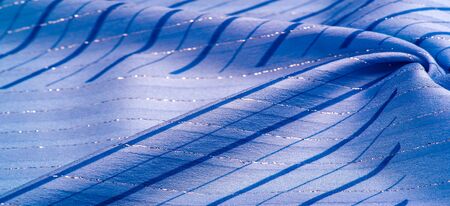 Texture background design, blue fabric with azure and white stripes of lurex, perfect for a fresh and comfortable style. の写真素材