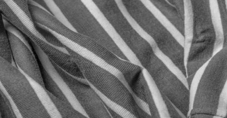 Texture, background, pattern, design, fabric from gray and white woolen stripes, woolen knitwear, which is elegant and pleasant to work with. Great for your projects.の写真素材