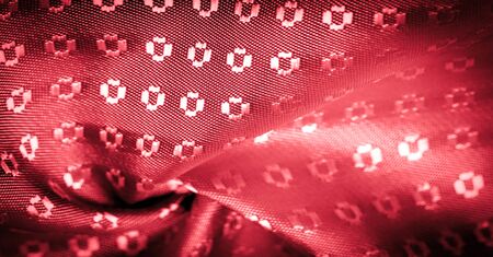 Background texture,  ruby red color of the fabric is thin, strong, soft, shiny fiber obtained by silkworms in the manufacture of cocoons and assembled for the manufacture of threads and fabrics.の写真素材