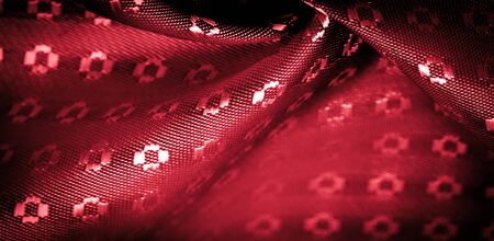 Background texture,  ruby red color of the fabric is thin, strong, soft, shiny fiber obtained by silkworms in the manufacture of cocoons and assembled for the manufacture of threads and fabrics.の写真素材