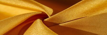 Texture, background, silk fabric, yellow amber. The photo is intended for, interior, imitation of a fashion designer, marketing, architecture, sketch, layout, surroundingsの写真素材