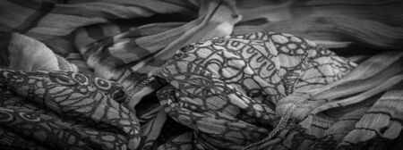 Background texture, Black and white silk fabric, silver. titanium. floral pattern, corrugation, reef, undulation, undulation, ripples, a small wave or a series of waves on the surface of the fabric,の写真素材