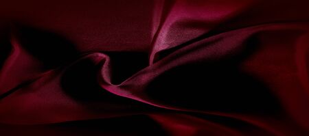 texture, red silk fabric panoramic photo. Silk Duke mood satin - beautiful and regal. It has a darker luster, then the usual satin on the one hand, has an average weight and has a more solid hand.の写真素材