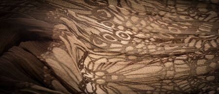 Background texture, decorative ornament, brown-beige silk fabric, floral pattern, corrugation, reef, undulation, undulation, ripples, a small wave or a series of waves on the surface of the fabric,の写真素材