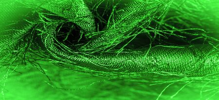 Background texture, decorative ornament, green silk fabric, woven threads on the fabric, fluffy effect, feeling, appearance or texture of the surfaceの写真素材