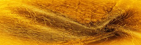 Background texture, decorative ornament, yellow gold silk fabric, woven threads on the fabric,...