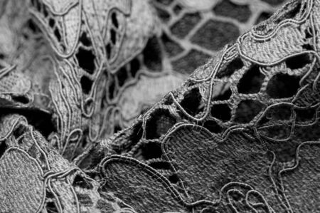 Texture, background, pattern, black lace fabric, delicate embossed lace fabric, scalloped on both edges. Suitable for your projects, design, etc.の写真素材