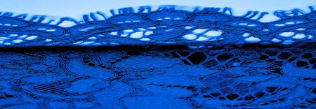 Texture, background, pattern, blue lace fabric, delicate embossed lace fabric, scalloped on both edges. Suitable for your projects, design, etc.の写真素材