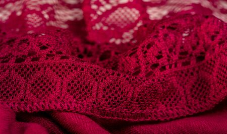 Background, texture, pattern, red lace fabric, thin open fabric, usually made of cotton or silk, made using loops, twisting or knitting threads in patternsの写真素材
