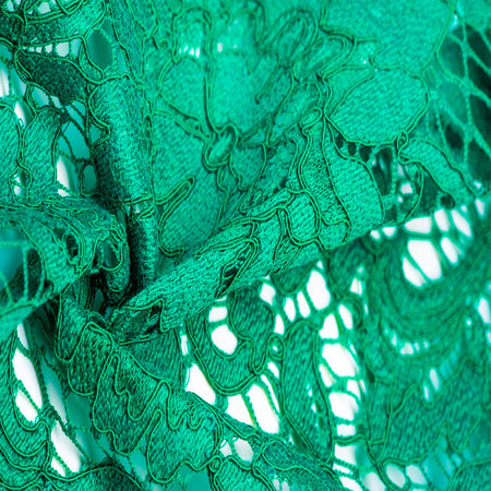Texture, background, pattern, green lace fabric, Tender embossed lace fabric, scalloped on both edges. Suitable for your projects, design, etc.の写真素材